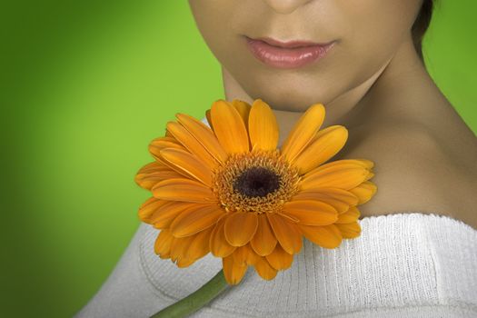 Beautiful woman with flowers on a green background