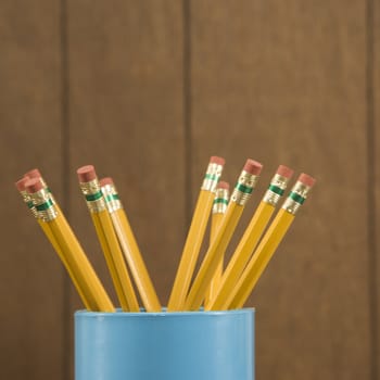 Close-up of a cup filled with wooden pencils.