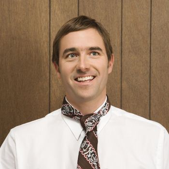 Mid-adult smiling Caucasian male with necktie.