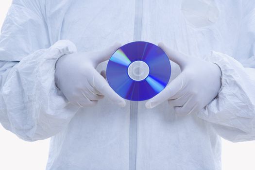 Close-up of man in biohazard suit and latex gloves holding compact disc.