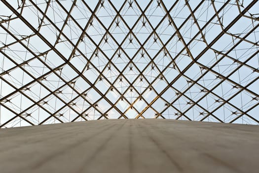 The photo is made under a glass dome of a pyramid in the Louvre