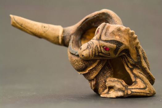 Dragon. Wood engraving. Tobacco pipe close up.