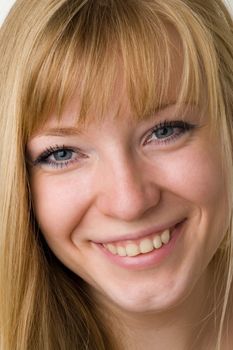 Portrait of the smiling young woman. The beautiful face close up.