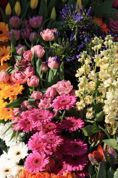 A floral arrangement on a Dutch flower parade: pink, yellow and white gerberas and tulips