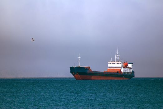 nave on roadstead before storm on sea