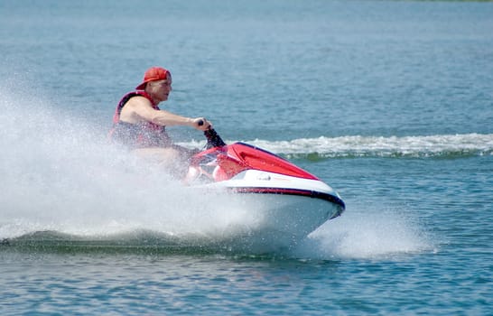 The man goes for a drive on a water motorcycle