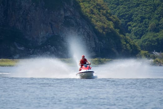 The man goes for a drive on a water motorcycle