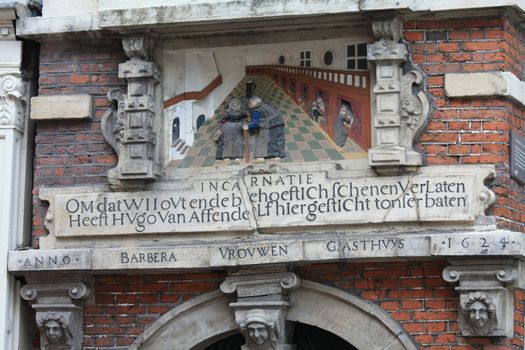 A historic plaque in the gateway of a former hospital in the city of Haarlem, the netherlands