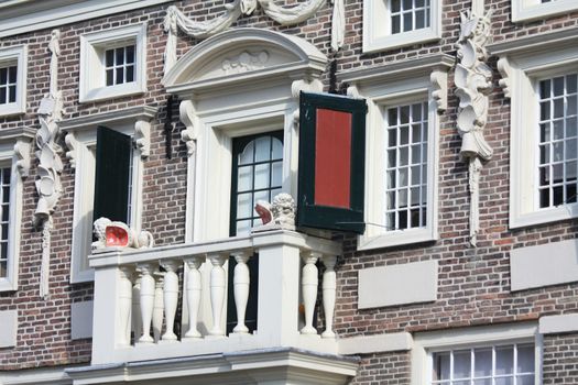 A small balcony on a historic dutch facade