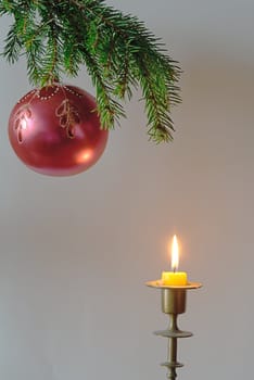 green  fir tree  twig and red ball and candle