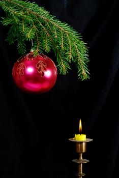 green  fir tree  twig and red ball and candle