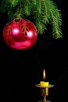 green  fir tree  twig and red ball and candle