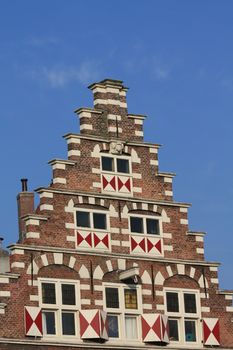 Windows with shutters in a traditional pattern on a classic crow stepped gable