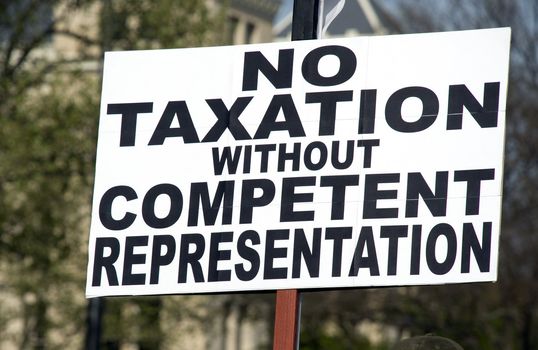 a sign at a tea party rally protesting USA tax laws