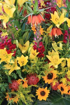 tigerlilies and sunflowers in a yellow flower arrangement