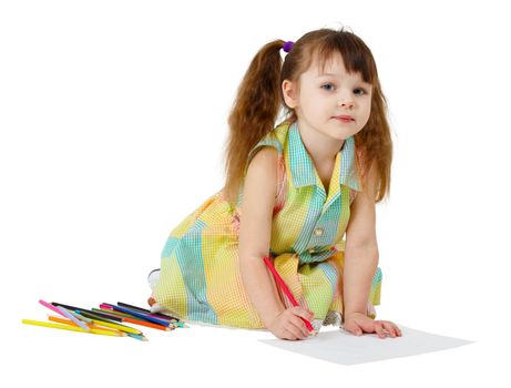 Child draws with colored pencils on the floor
