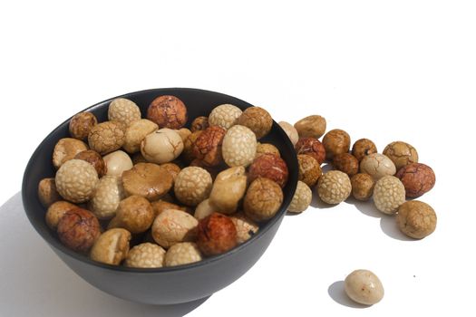 Bowl of Asian rice and sesame crackers against white background