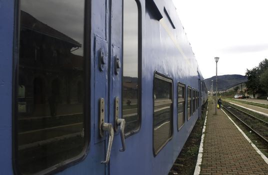 Eastern european passenger train with vanishing horizon down platform