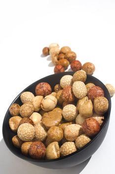 Bowl of Asian rice and sesame crackers against white background