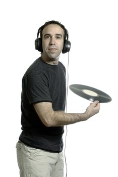 A young man wearing a set of headphones about to throw away an old LP record, isolated against a white background