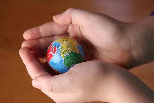 Child handing a globe