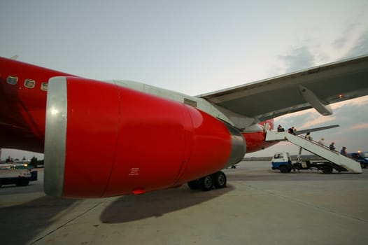 Red plane in an airport.