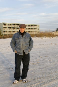 Middle-aged man on the beach in front of hotel.