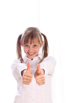 young girl with pigtails shows two thumbs up - on a white background-cutout