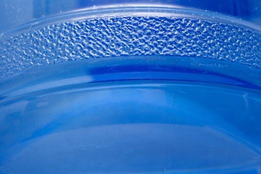 Blue plastic bottle with water. A background, macro