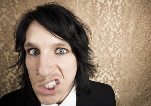 Wide angle closeup of a handsome angry man 