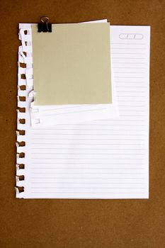 Note and sheet paper on brown background