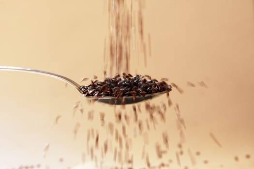 Flax seed falling in spoon