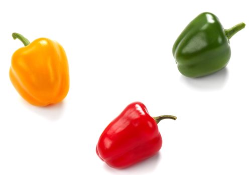 Yellow, green and red pepper on the white background.