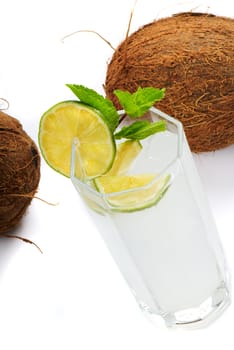 Cocktail pina colada on a white background with a slice of lime and mint. A close up
