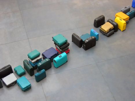 a row of luggage on the airport floor