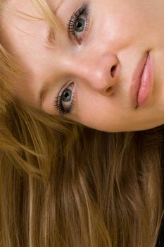 Portrait of the smiling young woman. The beautiful face close up.