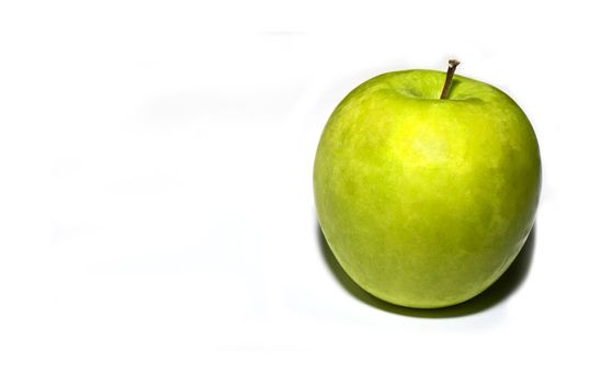A ripe granny SMith apple over a plain white background  