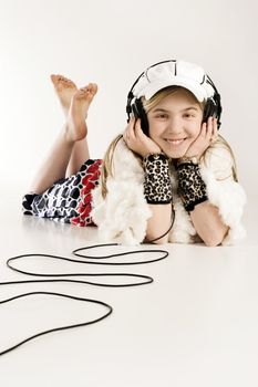 Adorable young female enjoying music on her headphones.
