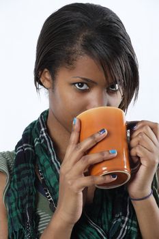 A beautiful female drinking from a mug of tea or coffee.