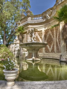 A medieval fountain in a public garden in Malta