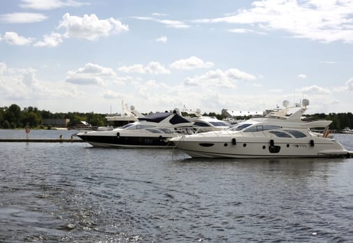 Two boats in river on a background of city