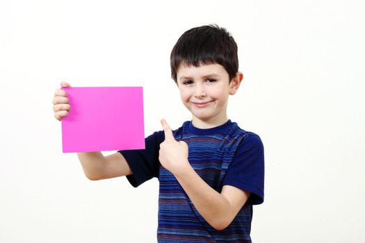 small boy with a color plate with space for your text on white background