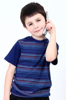 Small boy calling from mobile phone to friend on white background