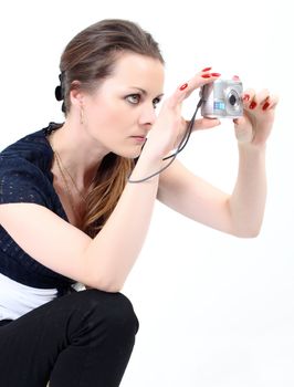 The attractive woman making photo with digital camera on white background 