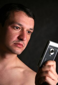 Portrait of the man with the phone in studio
