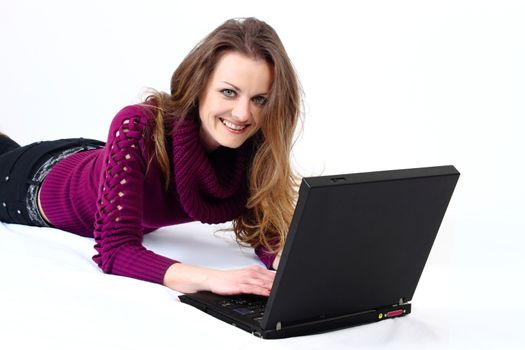 lying and smiling attractive woman with a laptop with white background