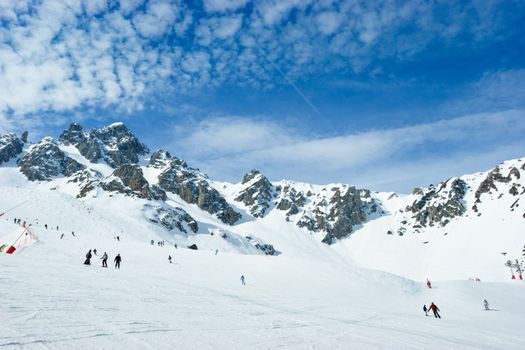 Skiers on a piste at Courchevel ski resort, French Alps