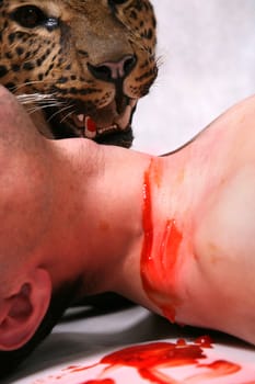 The man with blood on a throat and the leopard on a background