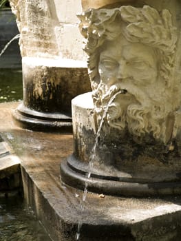 Detail of a medieval fountain in a public garden in Malta