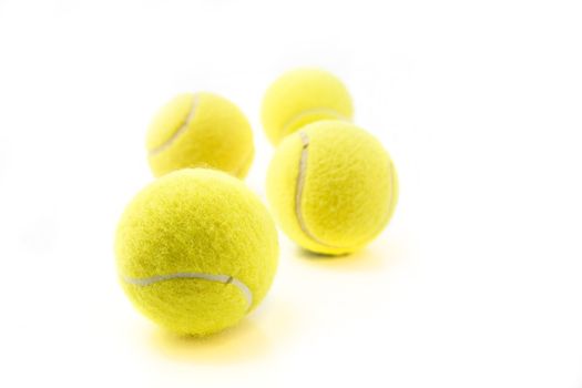 Four tennis balls isolated on white background